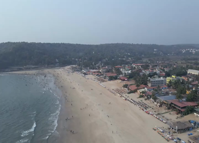 Aerial View of Baga Beach with Tourists and Shoreline Goa India