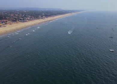 Aerial View of Baga Beach with Tourists and Shoreline Goa India