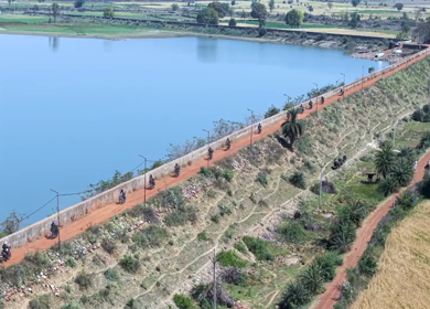 Aerial View of Bikers Riding Along Kolar Dam Reservoir Madhya Pradesh
