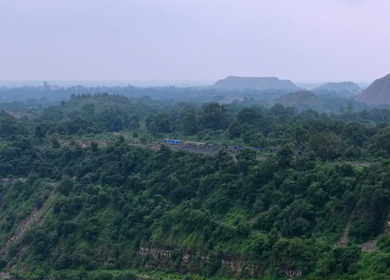 Aerial View of Freight Train Passing Through Rural Landscape in Mayapur West Bengal