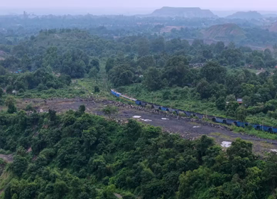 Aerial View of Freight Train Passing Through Rural Landscape in Mayapur West Bengal