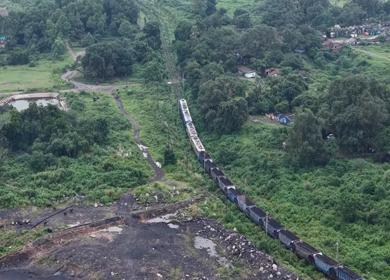 Aerial View of Freight Train Passing Through Rural Landscape in Mayapur West Bengal