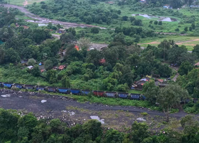 Aerial View of Freight Train Passing Through Rural Landscape in Mayapur West Bengal