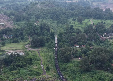 Aerial View of Freight Train Passing Through Rural Landscape in Mayapur West Bengal