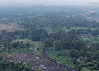 Aerial View of Freight Train Passing Through Rural Landscape in Mayapur West Bengal