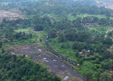 Aerial View of Freight Train Passing Through Rural Landscape in Mayapur West Bengal