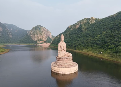 Aerial View of Giant Buddha Statue in Lake Surrounded by Hills Rajgir Bihar India