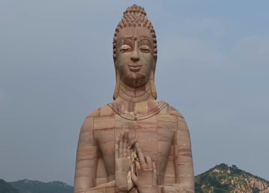 Aerial View of Giant Buddha Statue in Lake Surrounded by Hills Rajgir Bihar India