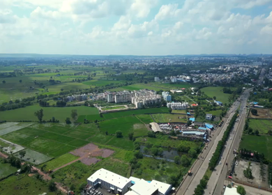 Aerial View of Highway Traffic and Green Agricultural Fields in Bhopal