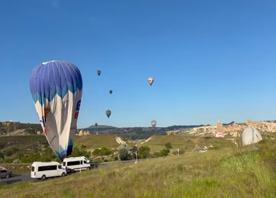 Aerial View of Hot Air Balloons Flying Over Cappadocia Landscape in Turkey