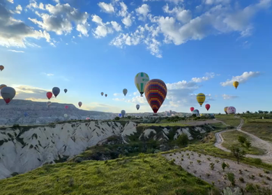 Aerial View of Hot Air Balloons Flying Over Cappadocia Landscape in Turkey
