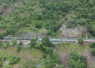 Aerial View of Indian Railways Freight Train Emerging from Tunnel Through Forested Hills, Andhra Pradesh