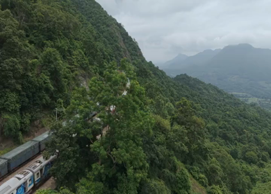 Aerial View of Indian Railways Freight Train Emerging from Tunnel Through Forested Hills, Andhra Pradesh