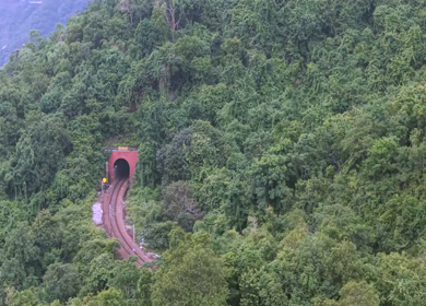 Aerial View of Indian Railways Freight Train Emerging from Tunnel Through Forested Hills, Andhra Pradesh