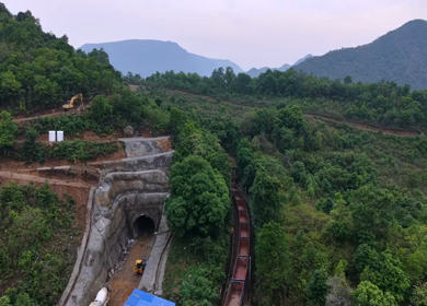 Aerial View of Indian Railways Freight Train Emerging from Tunnel Through Forested Hills, Andhra Pradesh