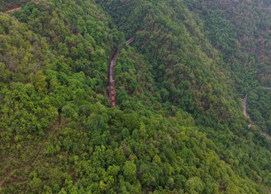Aerial View of Indian Railways Freight Train Emerging from Tunnel Through Forested Hills, Andhra Pradesh