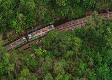 Aerial View of Indian Railways Freight Train Emerging from Tunnel Through Forested Hills, Andhra Pradesh