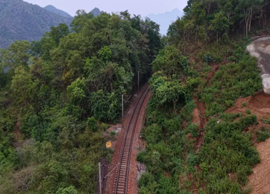 Aerial View of Indian Railways Freight Train Emerging from Tunnel Through Forested Hills, Andhra Pradesh