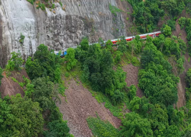 Aerial View of Indian Railways Freight Train Emerging from Tunnel Through Forested Hills, Andhra Pradesh