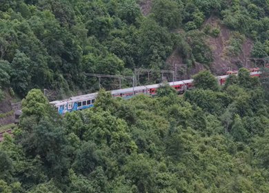Aerial View of Indian Railways Freight Train Emerging from Tunnel Through Forested Hills, Andhra Pradesh