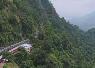 Aerial View of Indian Railways Freight Train Emerging from Tunnel Through Forested Hills, Andhra Pradesh