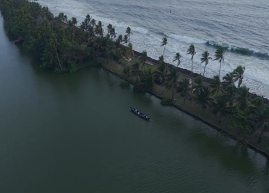 Aerial View of Kerala Backwaters with Coconut Trees and Boat in India