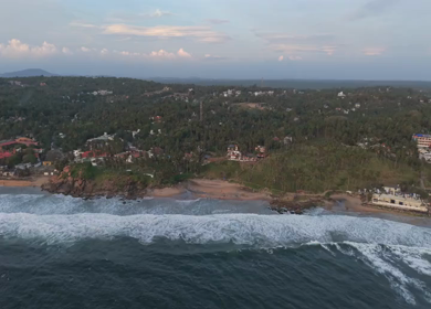 Aerial View of Kerala Coastline with Waves and Coconut Trees in India