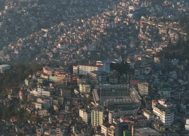 Aerial Drone View of Kohima City Stadium Surrounded by Urban Hills in Nagaland India