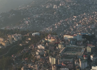 Aerial Drone View of Kohima City Stadium Surrounded by Urban Hills in Nagaland India