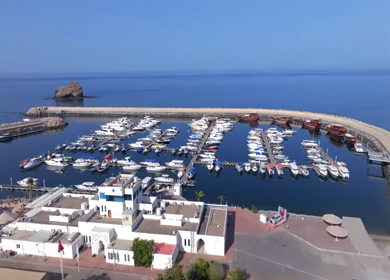 Aerial View of Marina Bandar Al Rowdha Muscat Oman with Yachts and Hajar Mountains