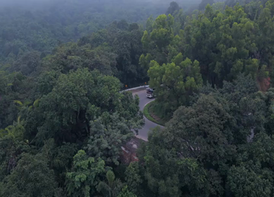 Aerial View of Misty Forest and Winding Road in Kanyakumari Tamil Nadu