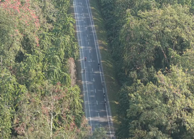 Aerial Drone View of Motorcyclists Riding Through Forest Road in Nagaland, India