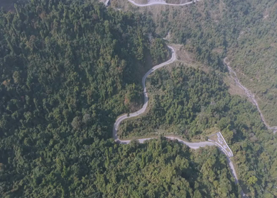 Aerial Drone View of Motorcyclists Riding Through Forest Road in Nagaland, India