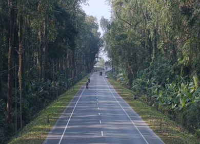 Aerial Drone View of Motorcyclists Riding Through Forest Road in Nagaland, India