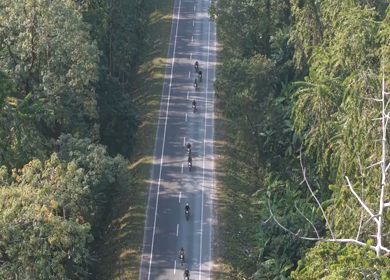 Aerial Drone View of Motorcyclists Riding Through Forest Road in Nagaland, India