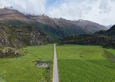 Aerial View of Mountain Road and Alpine Valley Near Lake Wanaka New Zealand