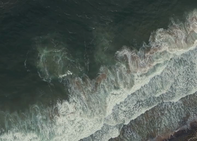Aerial View of Ocean Waves Crashing on Beach Kerala India