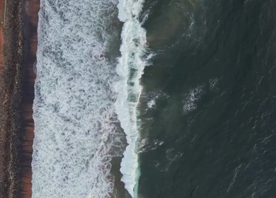 Aerial View of Ocean Waves Crashing on Beach Kerala India