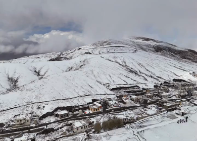 Aerial View of Snow Covered Village and Himalayan Mountains in Ladakh India