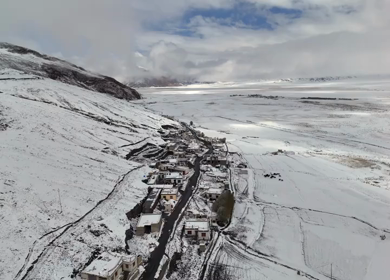Aerial View of Snow Covered Village and Himalayan Mountains in Ladakh India