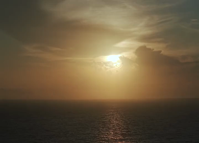 Aerial View of Sunset Over Ocean Horizon with Golden Light and Clouds in Kerala
