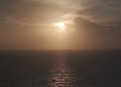 Aerial View of Sunset Over Ocean Horizon with Golden Light and Clouds in Kerala