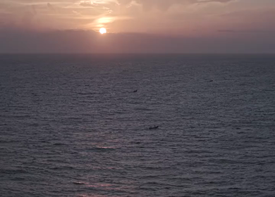 Aerial View of Sunset Over Ocean Horizon with Golden Light and Clouds in Kerala