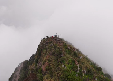 Aerial View of Tourists Standing on Kondarangi Hills Peak in Misty Clouds Tamil Nadu
