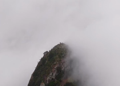 Aerial View of Tourists Standing on Kondarangi Hills Peak in Misty Clouds Tamil Nadu