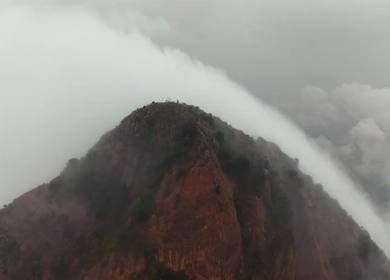 Aerial View of Tourists Standing on Kondarangi Hills Peak in Misty Clouds Tamil Nadu