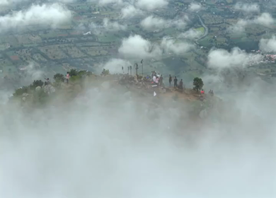 Aerial View of Tourists Standing on Kondarangi Hills Peak in Misty Clouds Tamil Nadu