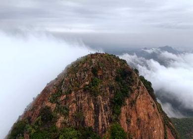 Aerial View of Tourists Standing on Kondarangi Hills Peak in Misty Clouds Tamil Nadu