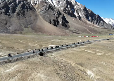 Aerial View of Tourists bike Riding Through Himalayan Valley in Ladakh India