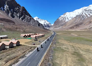 Aerial View of Tourists bike Riding Through Himalayan Valley in Ladakh India